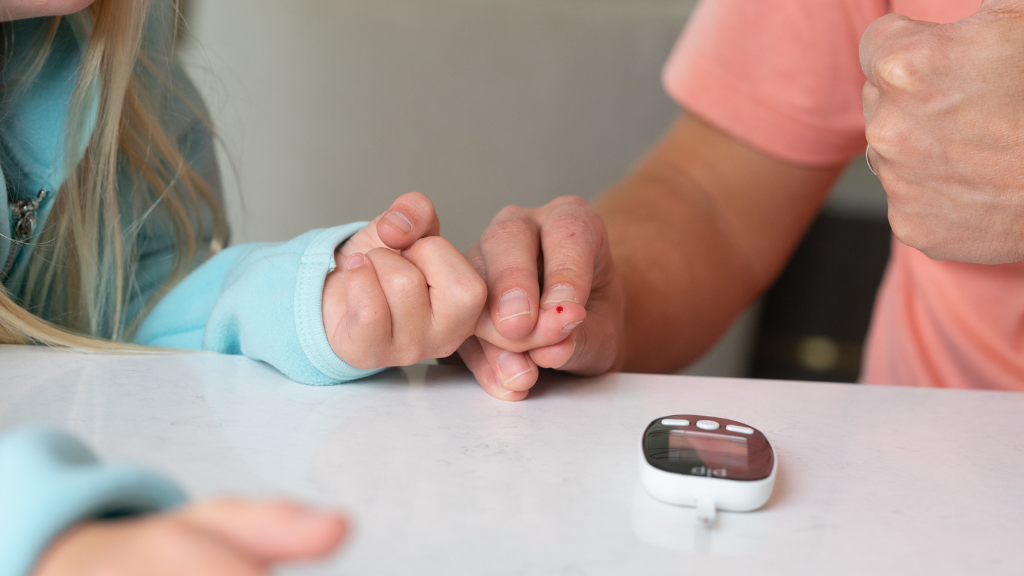 squeezing finger to test blood sugar